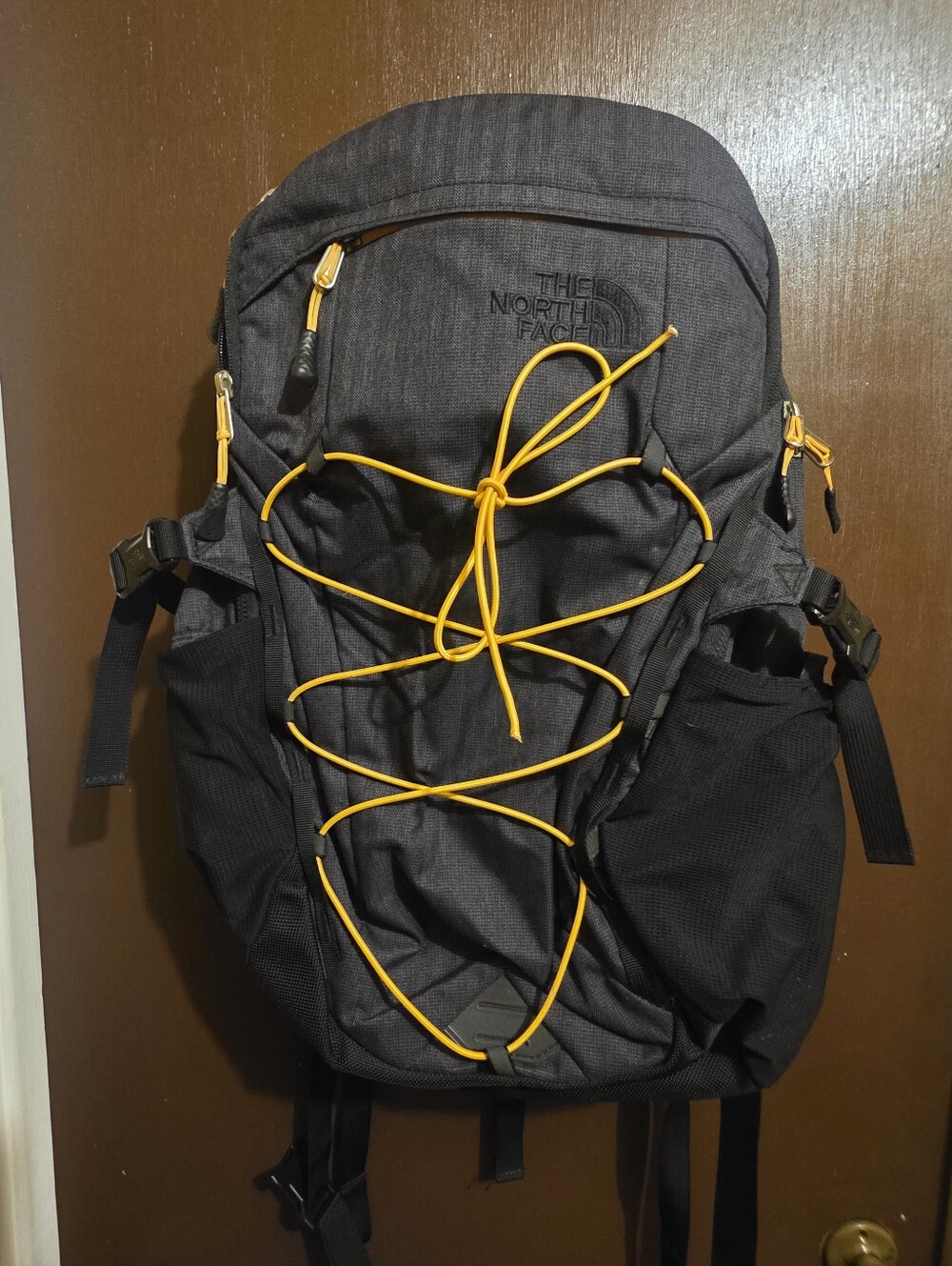 The North Face Black Backpack with Yellow Bungee Cord